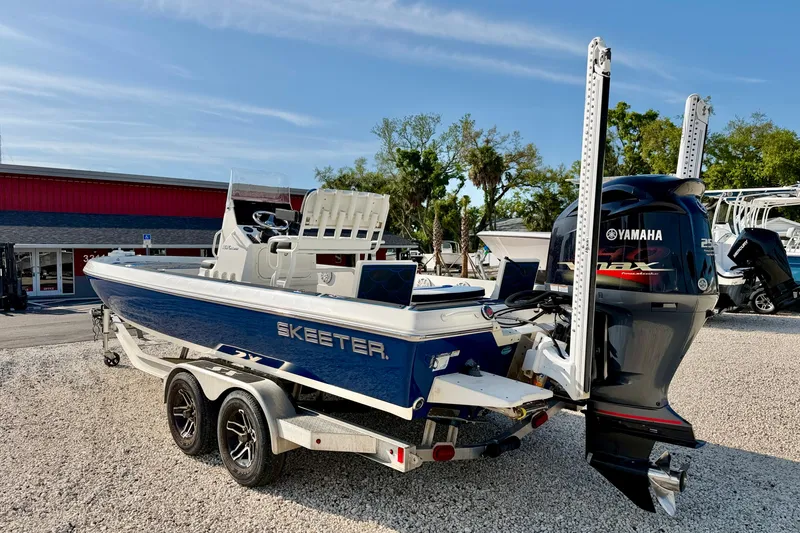 Slide: The Image of 2020 Skeeter SX230 boat with Yamaha engine on a trailer, parked outdoors. - 7