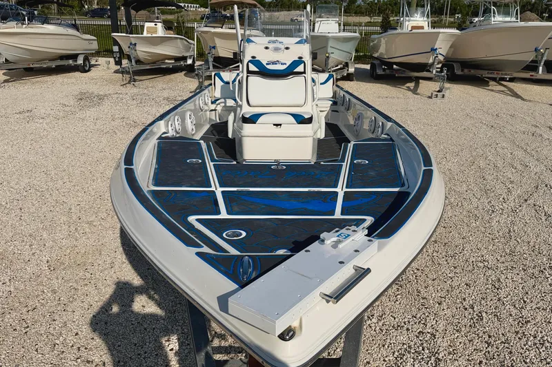 Slide: The Image of 2020 Skeeter SX230 boat with blue accents, displayed outdoors among other boats. - 8