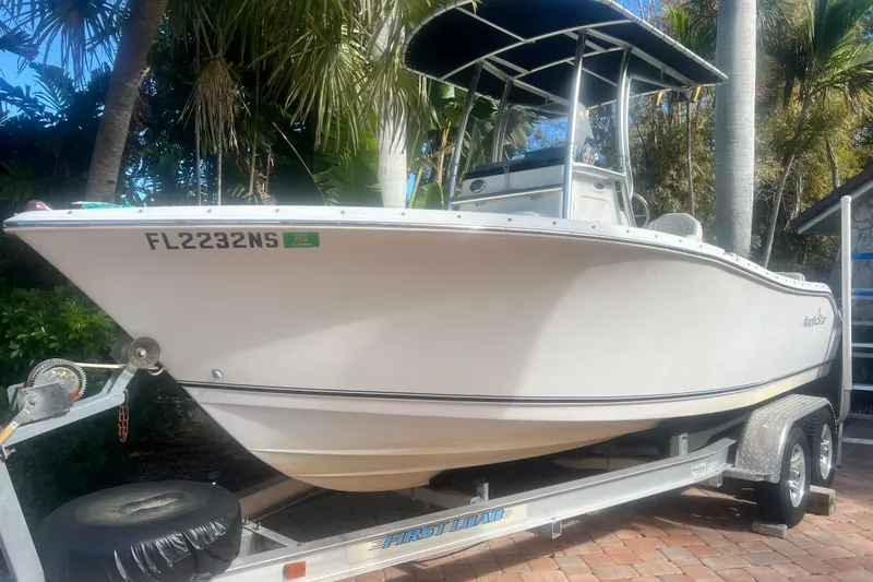 The Image of 2008 NauticStar 2000 Offshore boat on trailer, surrounded by tropical foliage. - 0