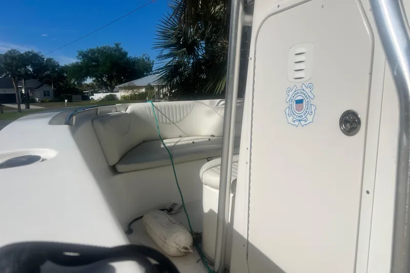 Slide: The Image of 2008 NauticStar 2000 Offshore boat interior with seating and U.S. Coast Guard emblem. - 11