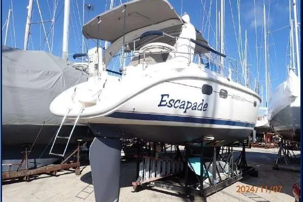 The Image of Hunter 380 sailboat named "Escapade" on dry dock, 1999 model, sunny day. - 0