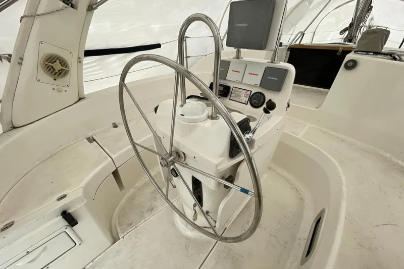 Slide: The Image of Steering wheel and controls of a 1999 Hunter 380 sailboat cockpit. - 10