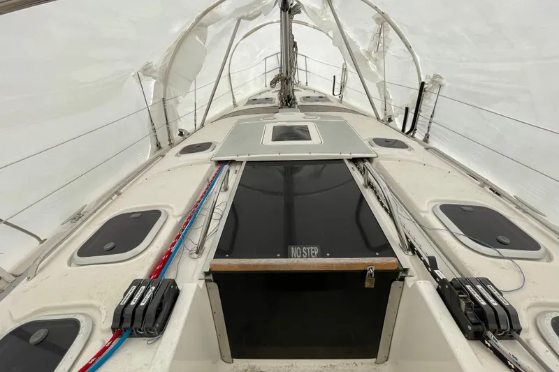 Slide: The Image of Interior view of a 1999 Hunter 380 sailboat under protective cover. - 14