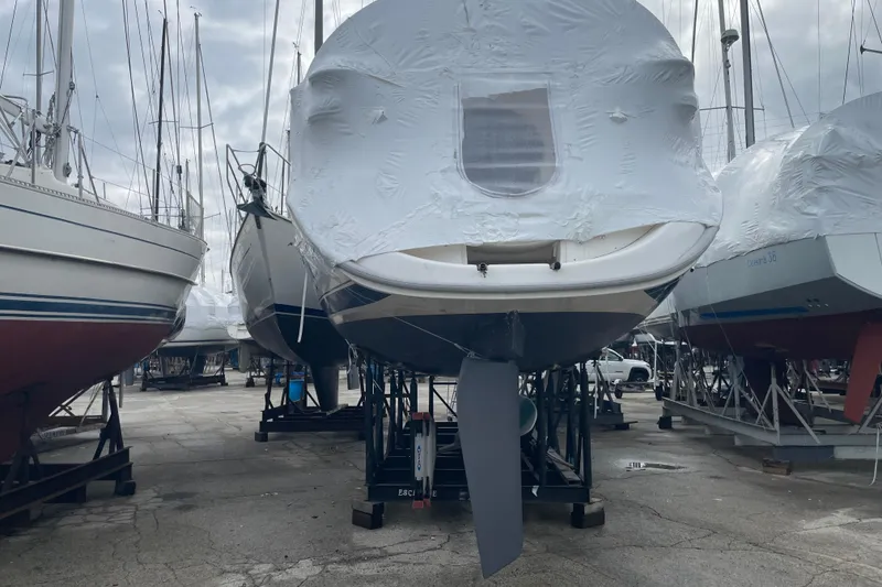 Slide: The Image of Covered 1999 Hunter 380 sailboat on stands in a boatyard. - 3
