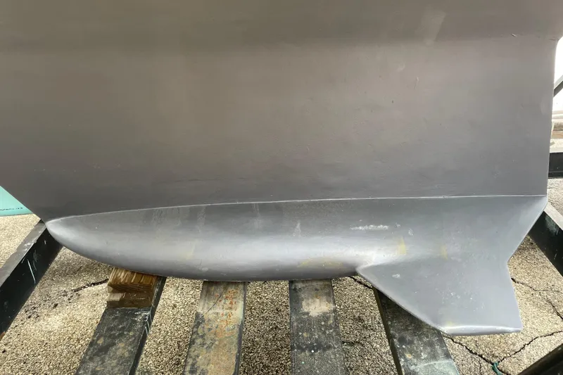 Slide: The Image of Close-up of a 1999 Hunter 380 sailboat keel on a trailer. - 5