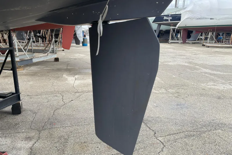 Slide: The Image of Rudder of a 1999 Hunter 380 sailboat in a boatyard setting. - 6