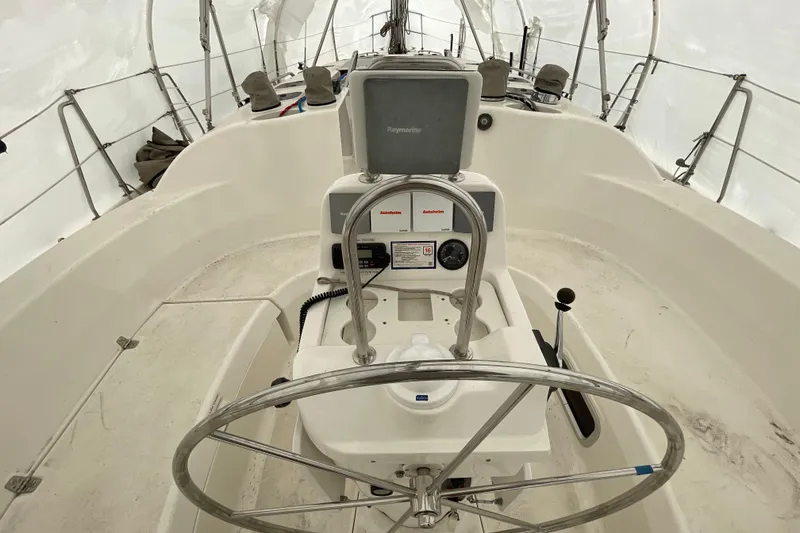 Slide: The Image of Cockpit of a 1999 Hunter 380 sailboat with steering wheel and navigation equipment. - 8