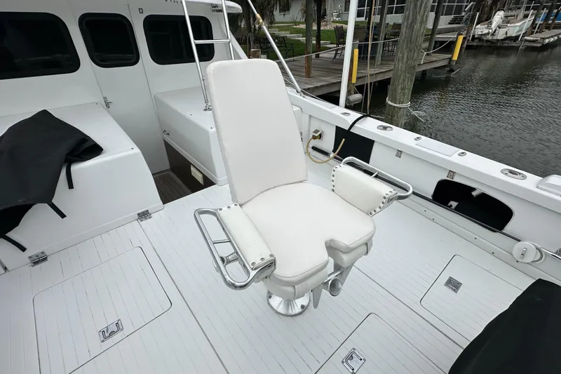 Slide: The Image of Fishing chair on 1975 Bertram 31 yacht deck, docked by the water. - 19