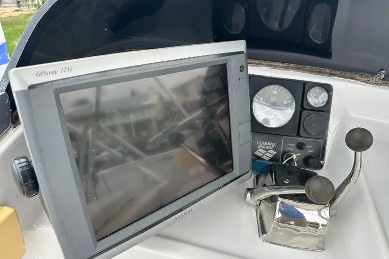Slide: The Image of Control panel of a 1975 Bertram 31 boat with GPSmap 7212 and Cummins Marine controls. - 22