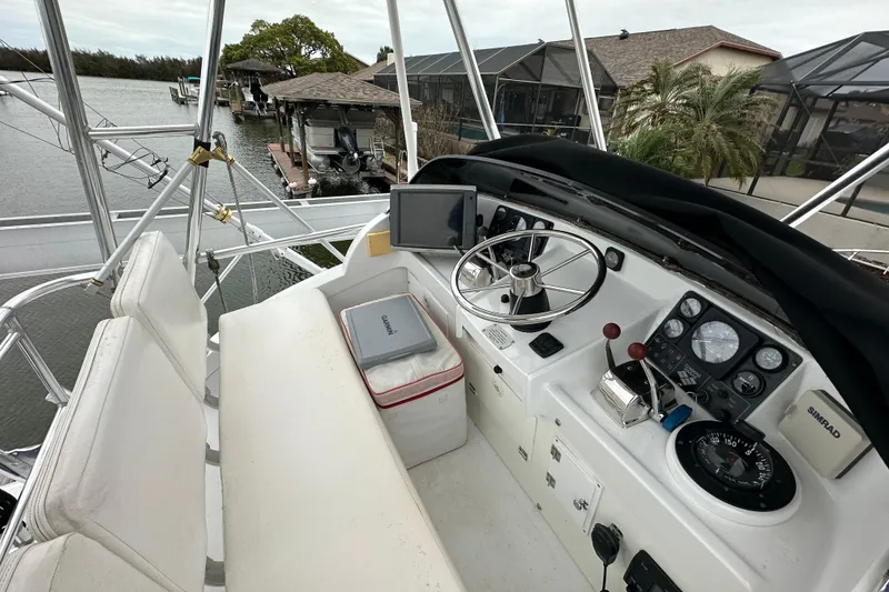 Slide: The Image of Cockpit of a 1975 Bertram 31 boat with steering wheel and navigation equipment. - 23
