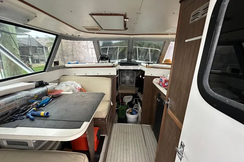 Slide: The Image of Interior of a 1975 Bertram 31 boat with tools and seating area. - 24