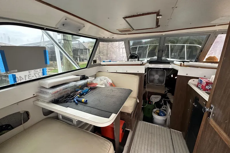 Slide: The Image of Interior of a 1975 Bertram 31 boat with tools and supplies on a table. - 25