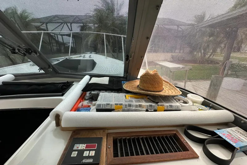 Slide: The Image of Interior view of a 1975 Bertram 31 boat with fishing gear and a straw hat. - 27