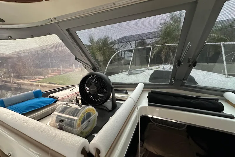 Slide: The Image of Interior view of a 1975 Bertram 31 boat cockpit with fan and fishing gear. - 29