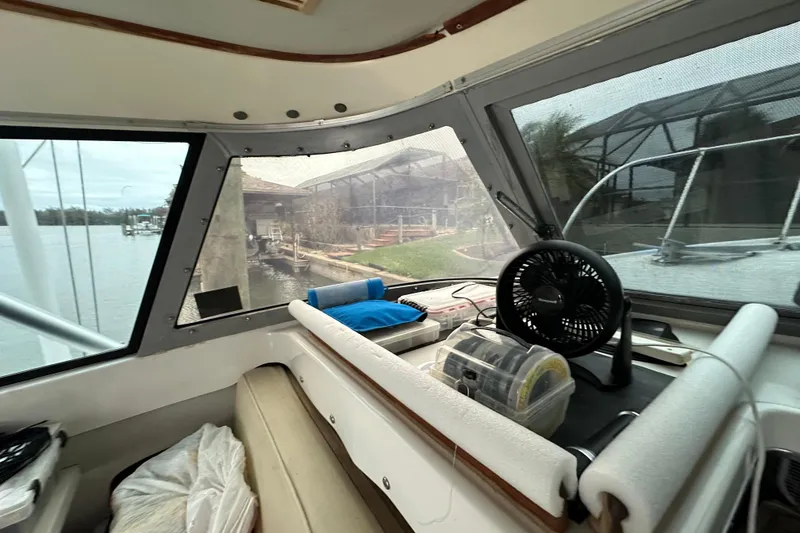Slide: The Image of Interior view of a 1975 Bertram 31 boat with fan and storage boxes. - 30