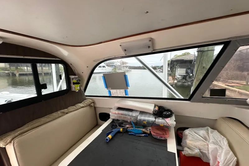 Slide: The Image of Interior view of a 1975 Bertram 31 boat with tools and supplies. - 32