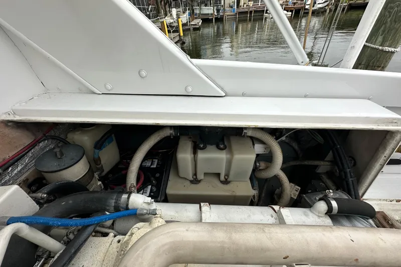Slide: The Image of Engine compartment of a 1975 Bertram 31 boat, showing various mechanical components. - 41