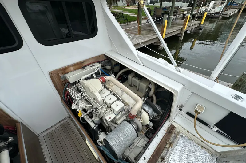 Slide: The Image of Engine compartment of a 1975 Bertram 31 boat, docked by the water. - 42