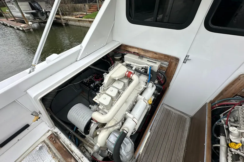 Slide: The Image of Engine compartment of a 1975 Bertram 31 boat, docked by the water. - 44