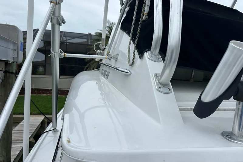 Slide: The Image of 1975 Bertram 31 boat deck with metal railings and dockside view. - 46