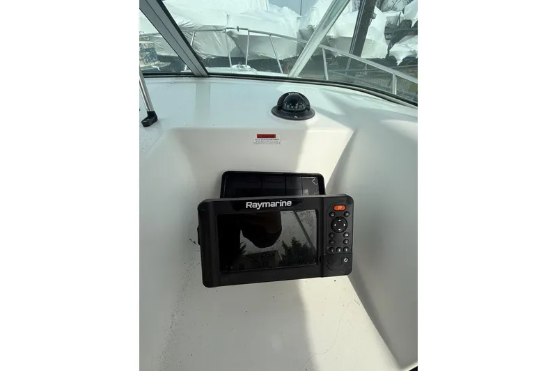 Slide: The Image of 2002 Wellcraft 22 Coastal Walkaround O/B boat dashboard with Raymarine navigation system. - 10