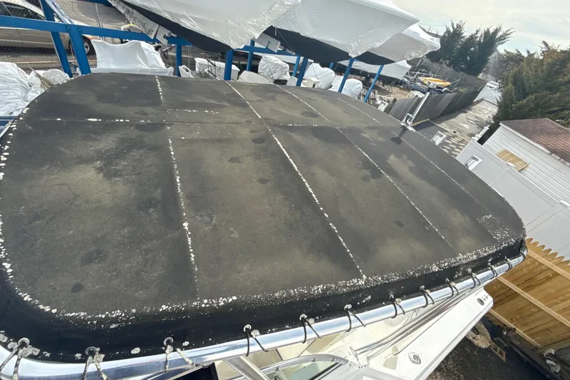 Slide: The Image of 2002 Wellcraft 22 Coastal Walkaround O/B boat cover, showing wear and weathering. - 21