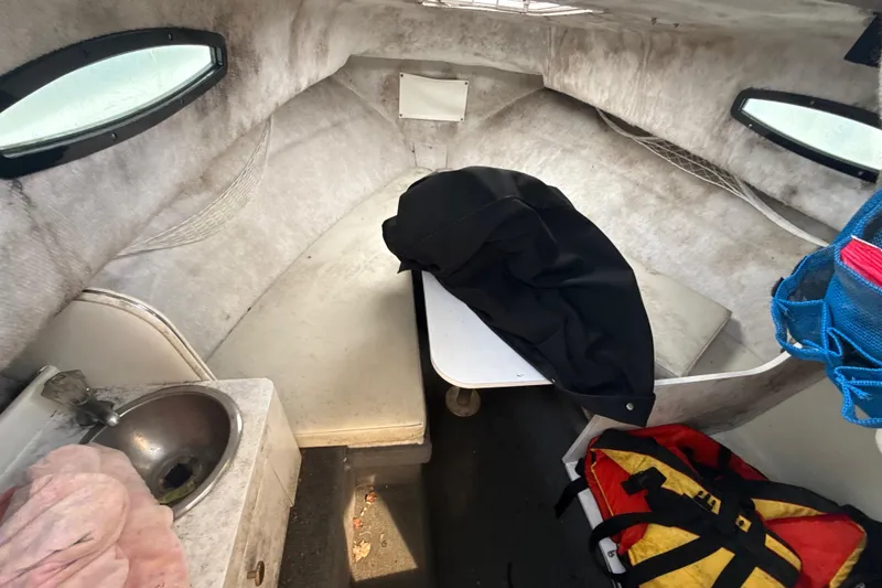 Slide: The Image of Interior of 2002 Wellcraft 22 Coastal Walkaround O/B boat cabin with sink and seating. - 22