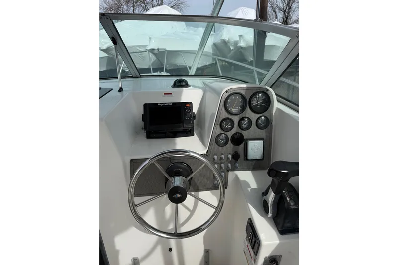 Slide: The Image of 2002 Wellcraft 22 Coastal Walkaround O/B boat dashboard with steering wheel and gauges. - 4