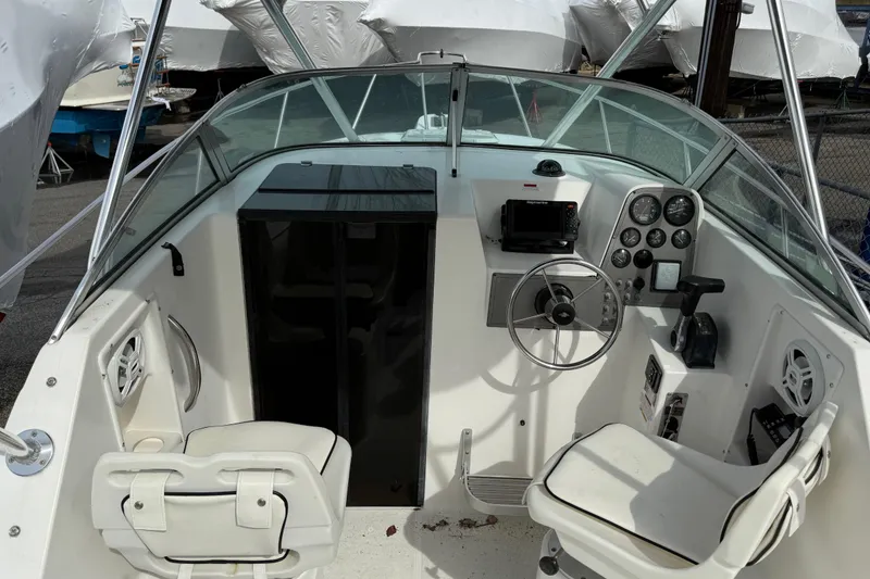 Slide: The Image of 2002 Wellcraft 22 Coastal Walkaround O/B boat interior with steering wheel and control panel. - 5