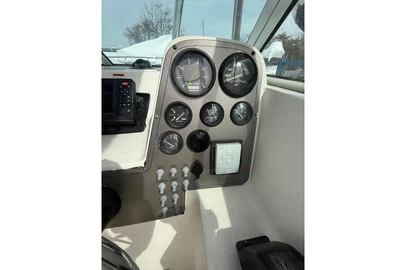 Slide: The Image of Dashboard of a 2002 Wellcraft 22 Coastal Walkaround O/B boat with gauges and controls. - 9