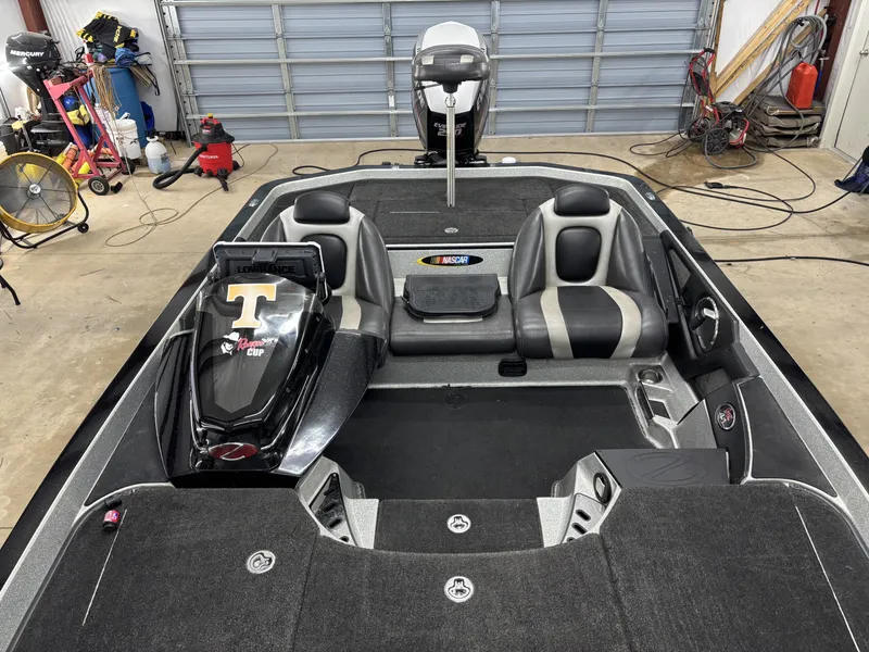 Slide: The Image of 2013 Ranger 520C boat in a garage with equipment. - 15