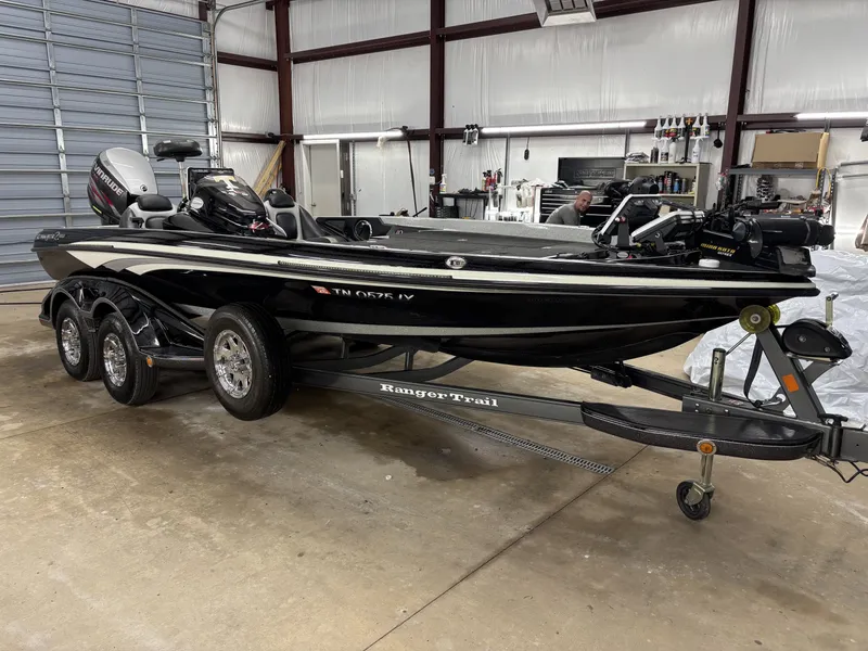 Slide: The Image of Black 2013 Ranger 520C boat in a garage setting. - 7