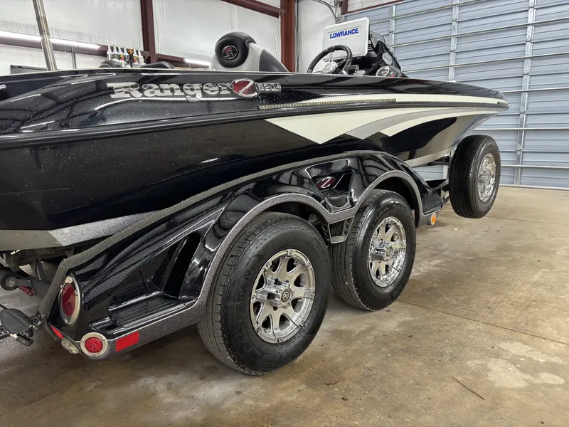 Slide: The Image of 2013 Ranger 520C boat in garage, black color, dual axle. - 8