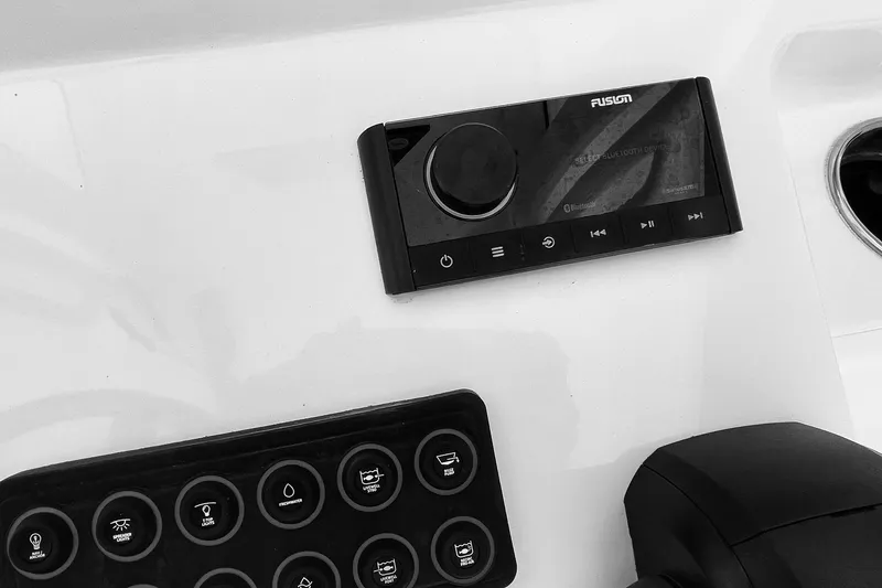 Slide: The Image of Control panel of 2024 Sportsman Masters 247 Bay Boat with audio system and switches. - 10