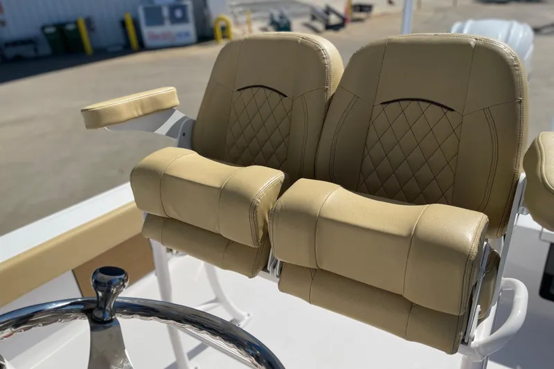Slide: The Image of 2024 Sportsman Masters 247 Bay Boat with luxurious tan seating and steering wheel. - 11