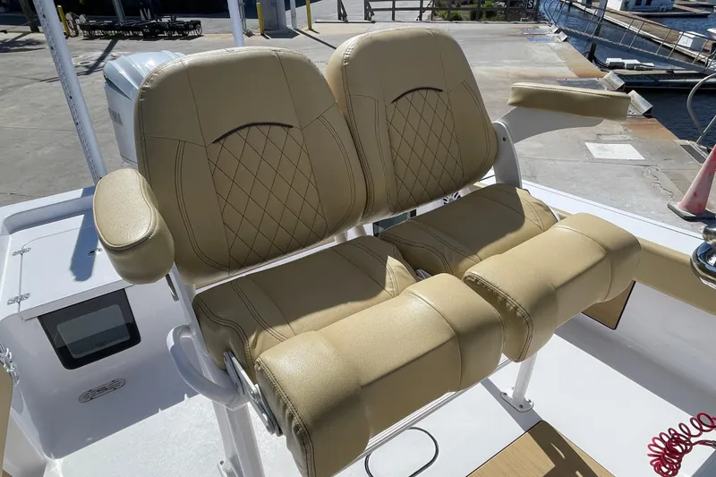 Slide: The Image of 2024 Sportsman Masters 247 Bay Boat with tan leather seats, docked at marina. - 12