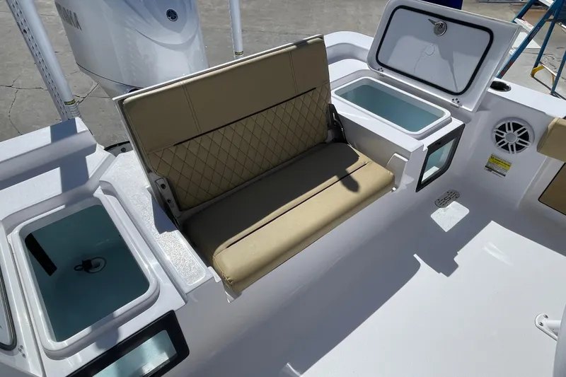 Slide: The Image of 2024 Sportsman Masters 247 Bay Boat interior with cushioned seating and storage compartments. - 13