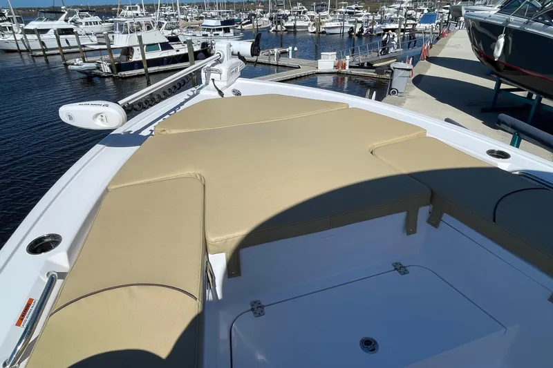 Slide: The Image of 2024 Sportsman Masters 247 Bay Boat with cushioned deck at marina. - 16