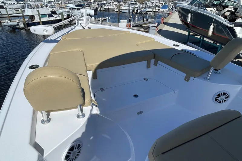 Slide: The Image of 2024 Sportsman Masters 247 Bay Boat with beige seating, docked at a marina. - 17