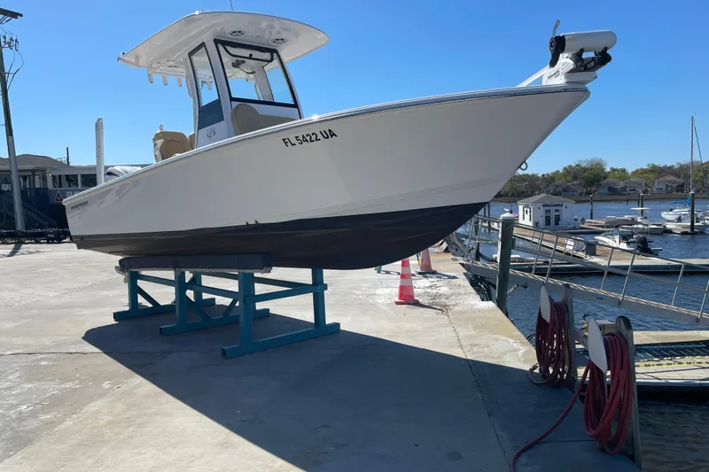 Slide: The Image of 2024 Sportsman Masters 247 Bay Boat on dock, marina background, sunny day. - 2