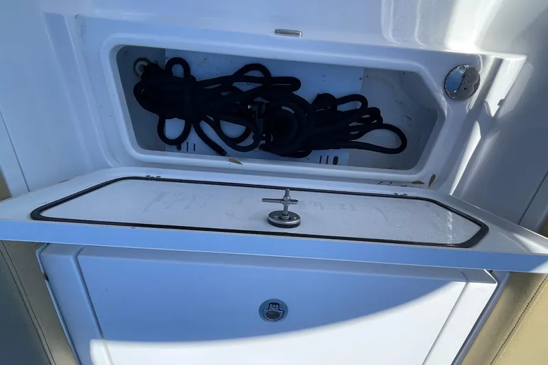 Slide: The Image of Storage compartment on a 2024 Sportsman Masters 247 Bay Boat, featuring coiled ropes. - 20