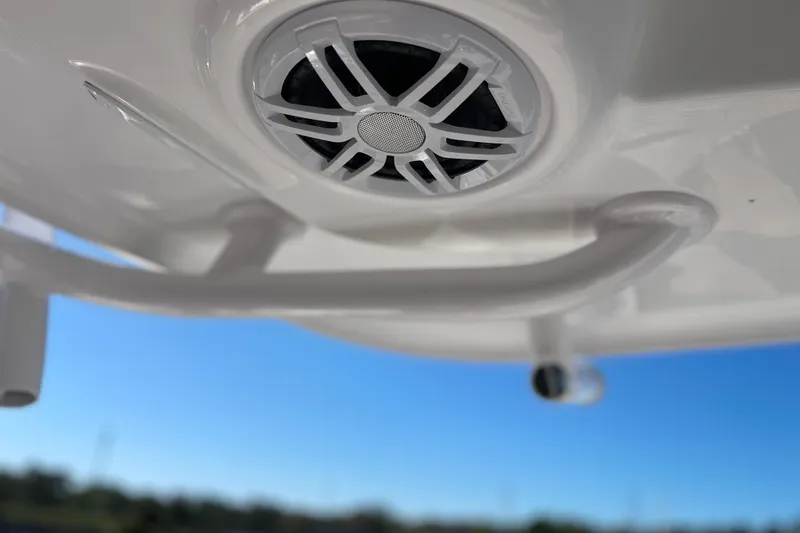 Slide: The Image of 2024 Sportsman Masters 247 Bay Boat speaker and handle detail against blue sky. - 22