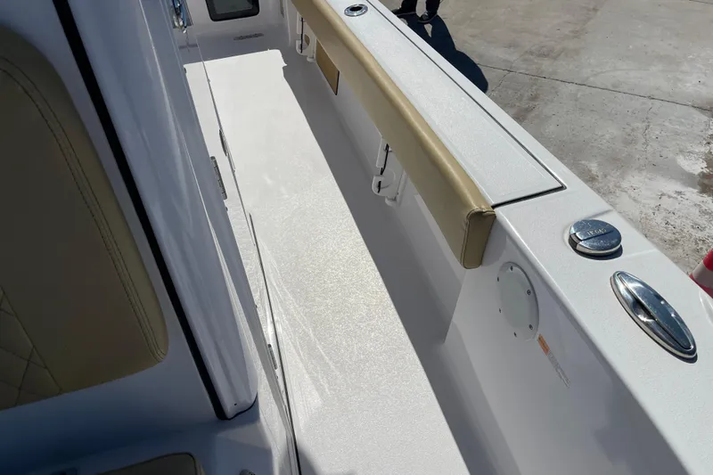 Slide: The Image of 2024 Sportsman Masters 247 Bay Boat interior with beige seating and sleek design. - 24