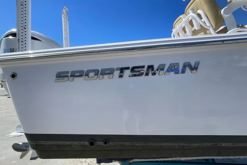 Slide: The Image of 2024 Sportsman Masters 247 Bay Boat side view with logo, showcasing sleek design. - 3