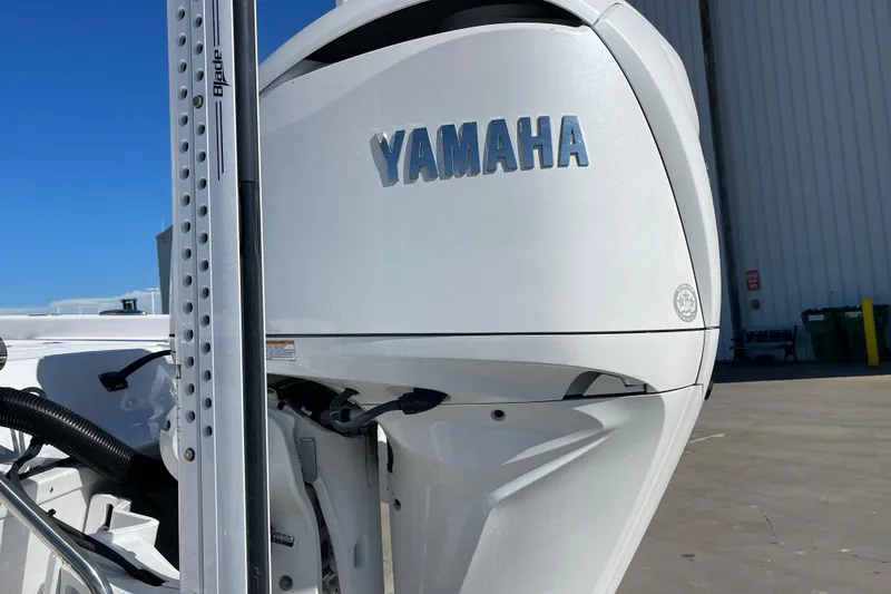 Slide: The Image of 2024 Sportsman Masters 247 Bay Boat with Yamaha engine, docked outdoors. - 35