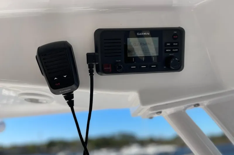 Slide: The Image of Garmin radio system on 2024 Sportsman Masters 247 Bay Boat, featuring a microphone and control panel. - 9