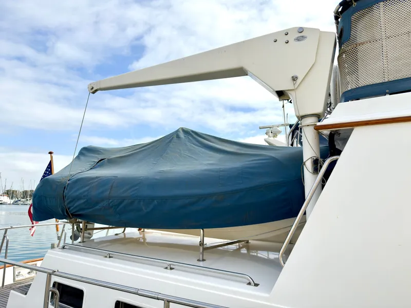 Slide: The Image of 2003 Grand Banks Classic yacht with cover in harbor. - 10