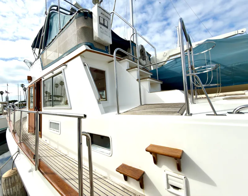 Slide: The Image of 2003 Grand Banks Classic yacht with wooden details and stainless steel railings. - 11