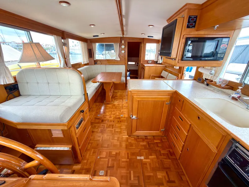 Slide: The Image of Interior of a 2003 Grand Banks Classic yacht with wooden furnishings. - 15