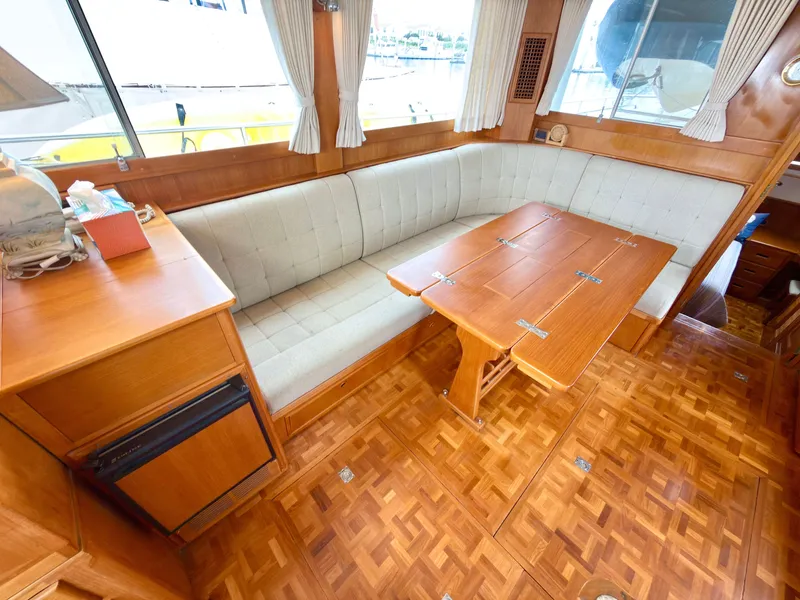 Slide: The Image of Interior of a 2003 Grand Banks Classic yacht with wood flooring and seating area. - 17